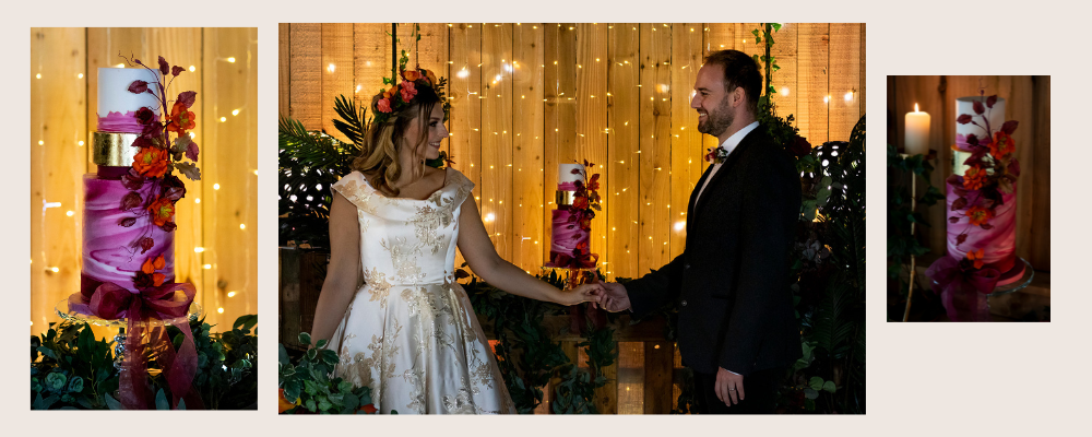 Bride and groom holding hands with backdrop of 3-tier pink and white marble cake with tip white tier and orange sugar flowers